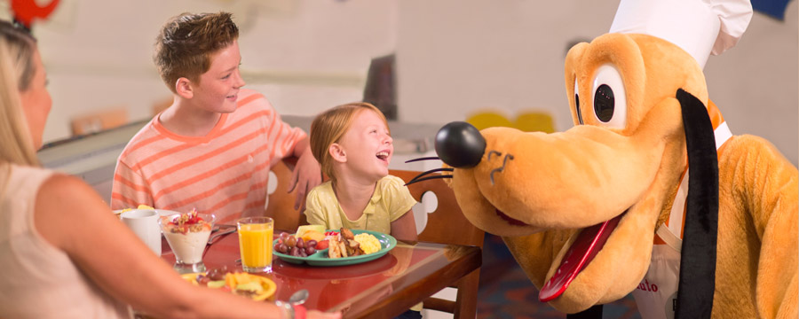 Mother and daughter with Pluto at Chef Mickey's
