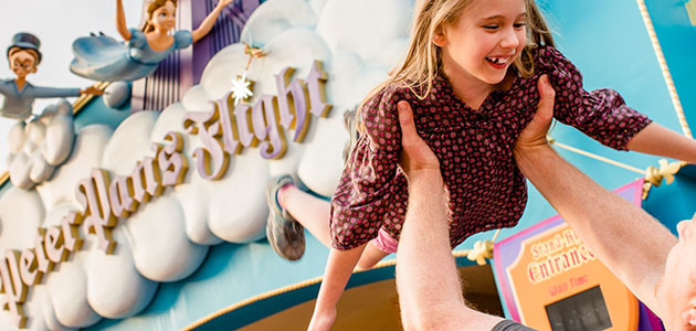 Young girl and father outside Peter Pan's Flight in Magic Kingdom Park.