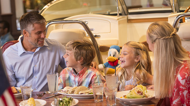 Family having dinner in an amphicar at The Boathouse, Disney Springs