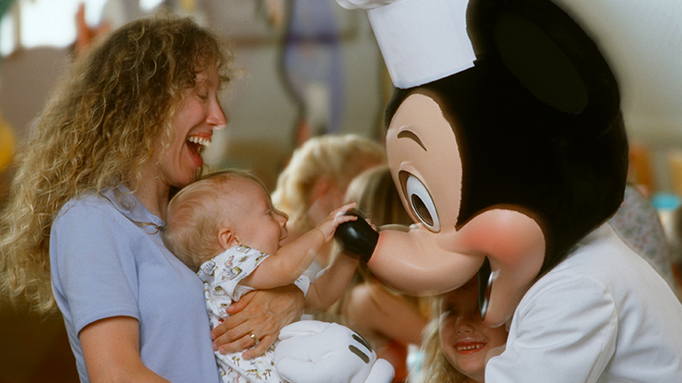 Mother and baby meeting Mickey Mouse at Character Dining