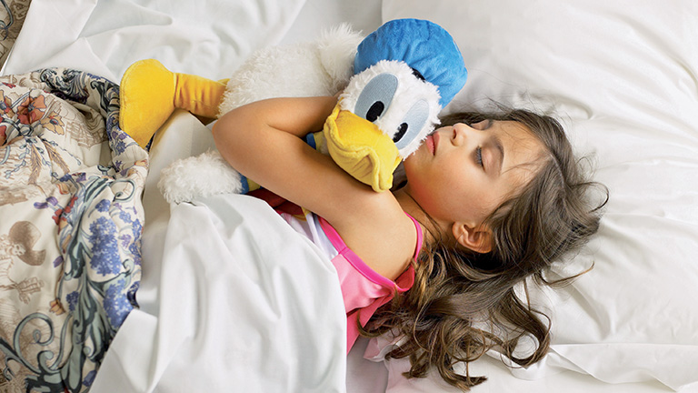 Young guest hugging Donald Duck plush