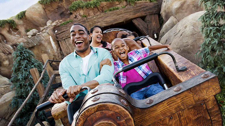 Father and son enjoying the Seven Dwarfs Mine Train ride