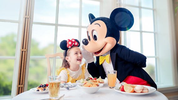 young-girl-having-breakfast-with-mickey-mouse