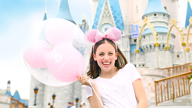 Teenager at Cinderella Castle in Magic Kingdom theme park